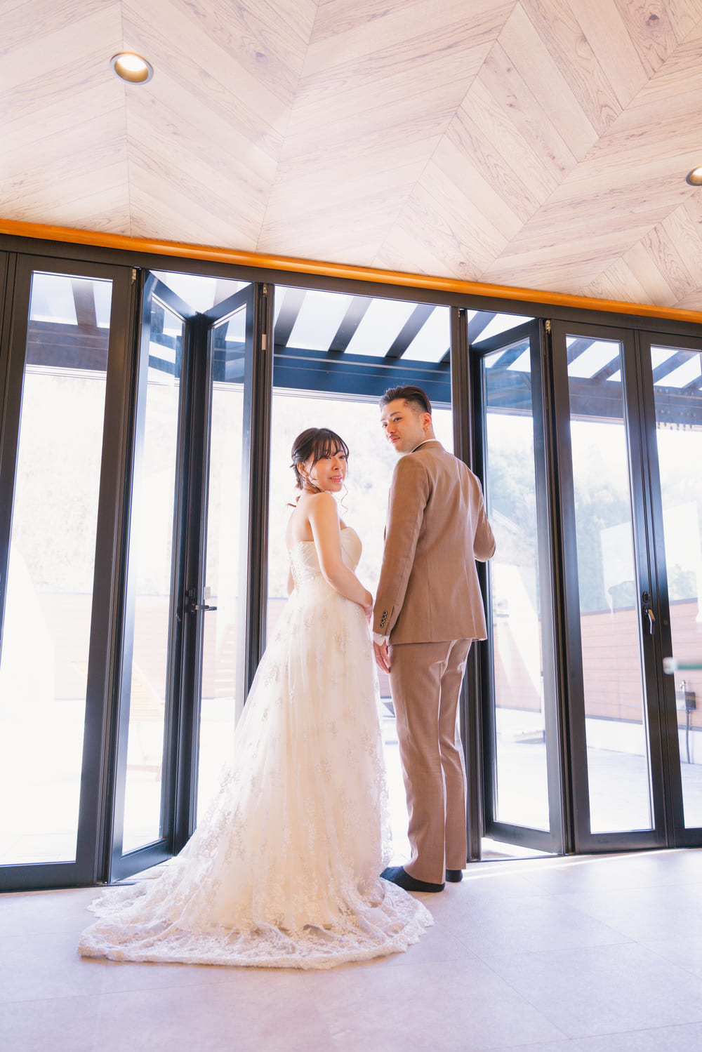 ガラス扉の前に立つ新郎新婦